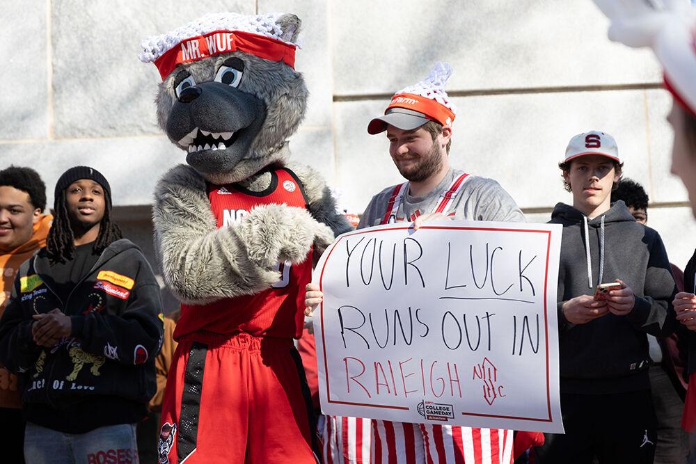 Bishop McGregor, a second-year studying biology, holds up a sign with Mr. Wuf at the Memorial Belltower on Sunday, Feb. 23, 2025. The crowd celebrated a women's basketball upset over Notre Dame, the #1 team in the nation.