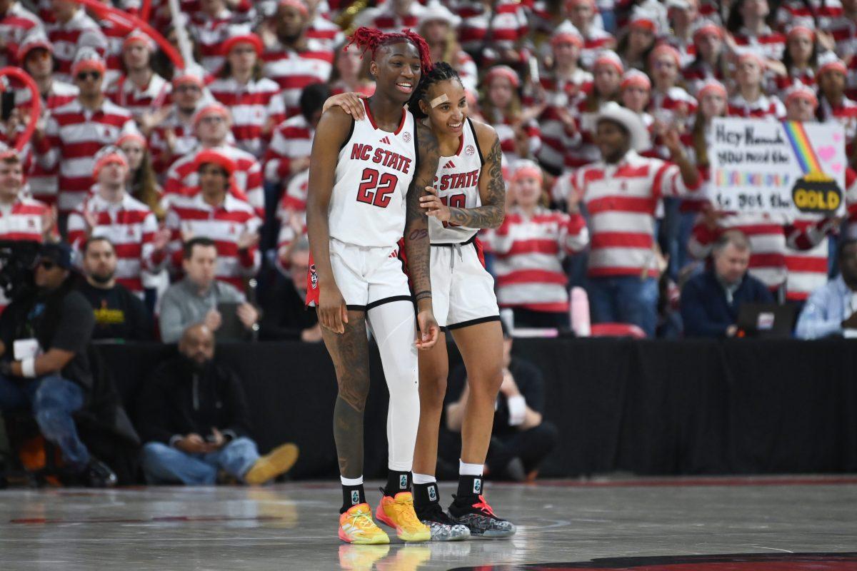 Senior guard Saniya Rivers and senior guard Aziaha James hug during the second overtime period of NC State's game against Notre Dame in Reynolds Coliseum on Sunday, Feb. 23, 2025. The Wolfpack beat the Fighting Irish 104-95.