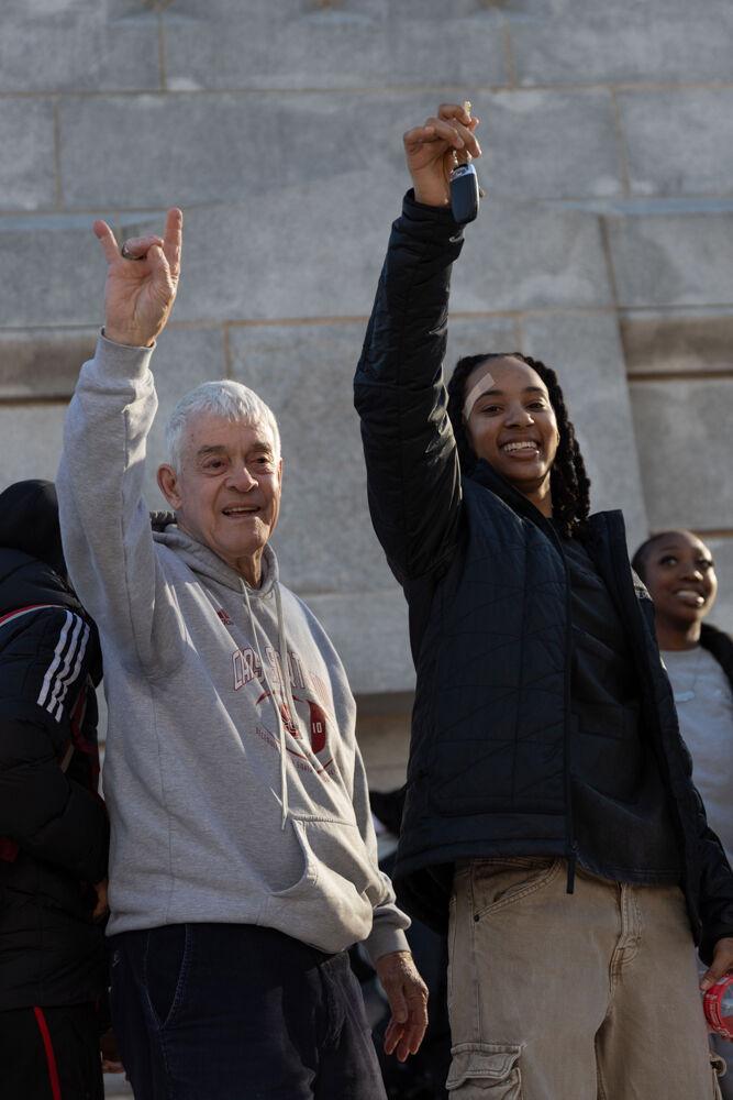 Dr. Thomas Stafford cheers with senior guard Aziaha James at the Memorial Belltower on Sunday, Feb. 23, 2025. Dr. Stafford gave James the key to the Belltower to celebrate the team's victory.