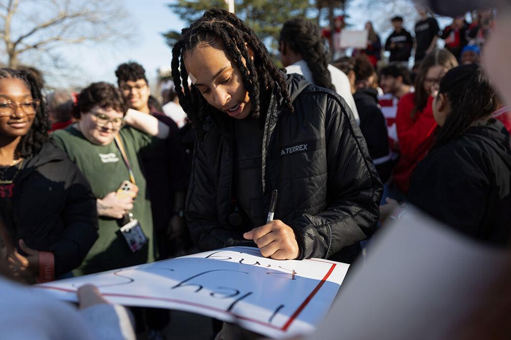 Senior guard Aziaha James autographs fan signs at the Memorial Belltower on Sunday, Feb. 23, 2025. The crowd celebrate the women's basketball team's 104-95 defeat over top-ranked Notre Dame.