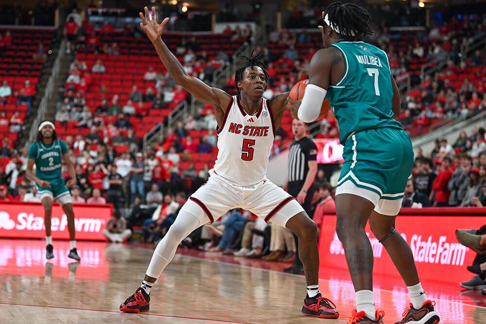 Freshman guard Trey Parker guards the ball in the press during the game against Coastal Carolina in the Lenovo Center on Wednesday, Nov. 13, 2024. Parker finished with 13 points off the bench. The Wolfpack won against the Chanticleers 82-70.&#160;