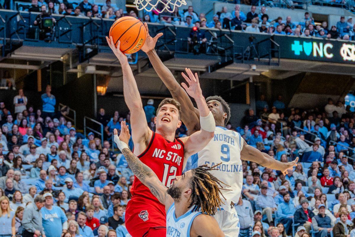 Graduate guard Michael O'Connell attempts a layup during the game against the University of North Carolina in the Dean E. Smith Center on Wednesday, Feb. 19, 2025. O'Connell scored eight points and made two rebounds. NC State lost the game 97-73.