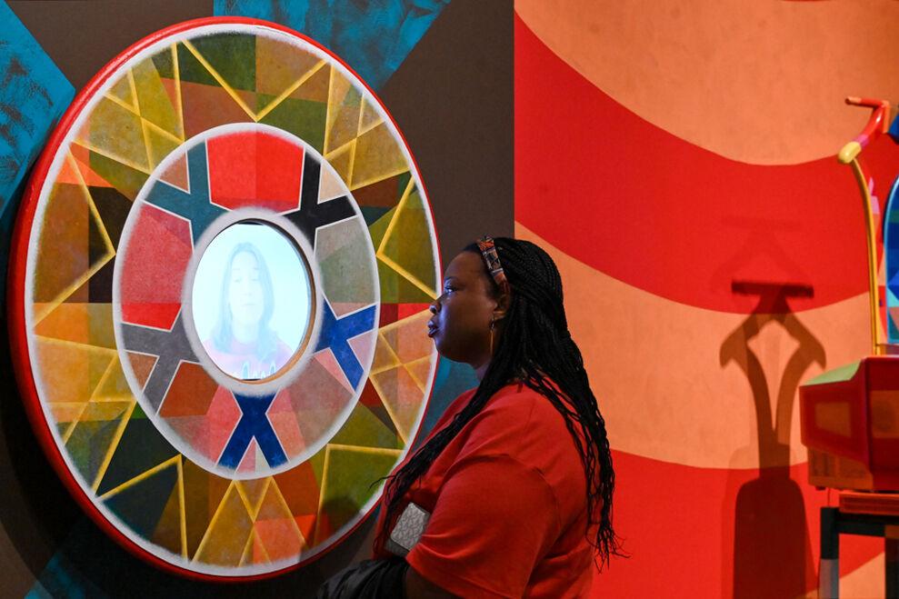 Ariel Saey-Howard, assistant professor of communications, race and rhetoric, observes a piece of artwork by Carl Joe Williams at the Gregg Museum of Art &amp; Design on Thursday, Feb. 6, 2025. Williams' immersive exhibition titled "Amazing Grace" explores the complexities of race as a social construct.