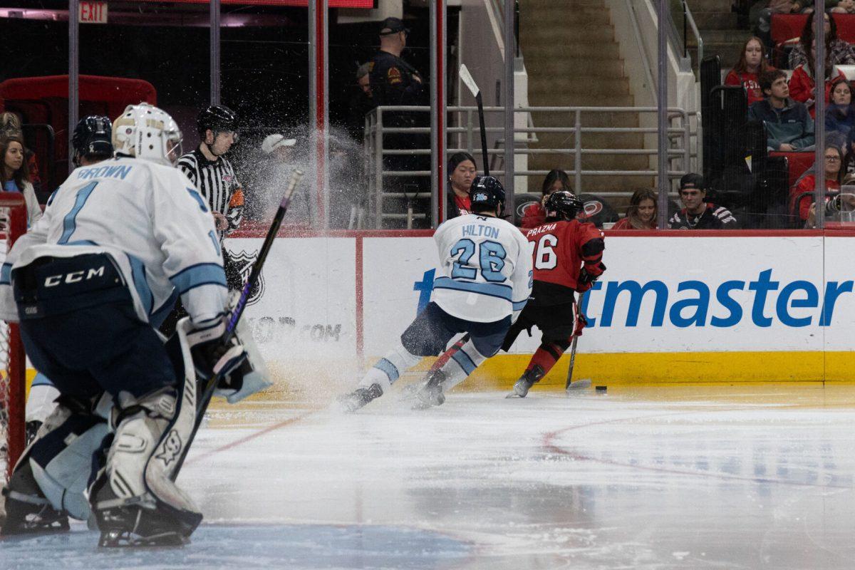 Freshman forward Daniel Prazma chased by a defender during the Governors Cup against the University of North Carolina at the Lenovo Center on Sunday, Feb. 2, 2025. The Wolfpack beat The Tarheels 4-1.