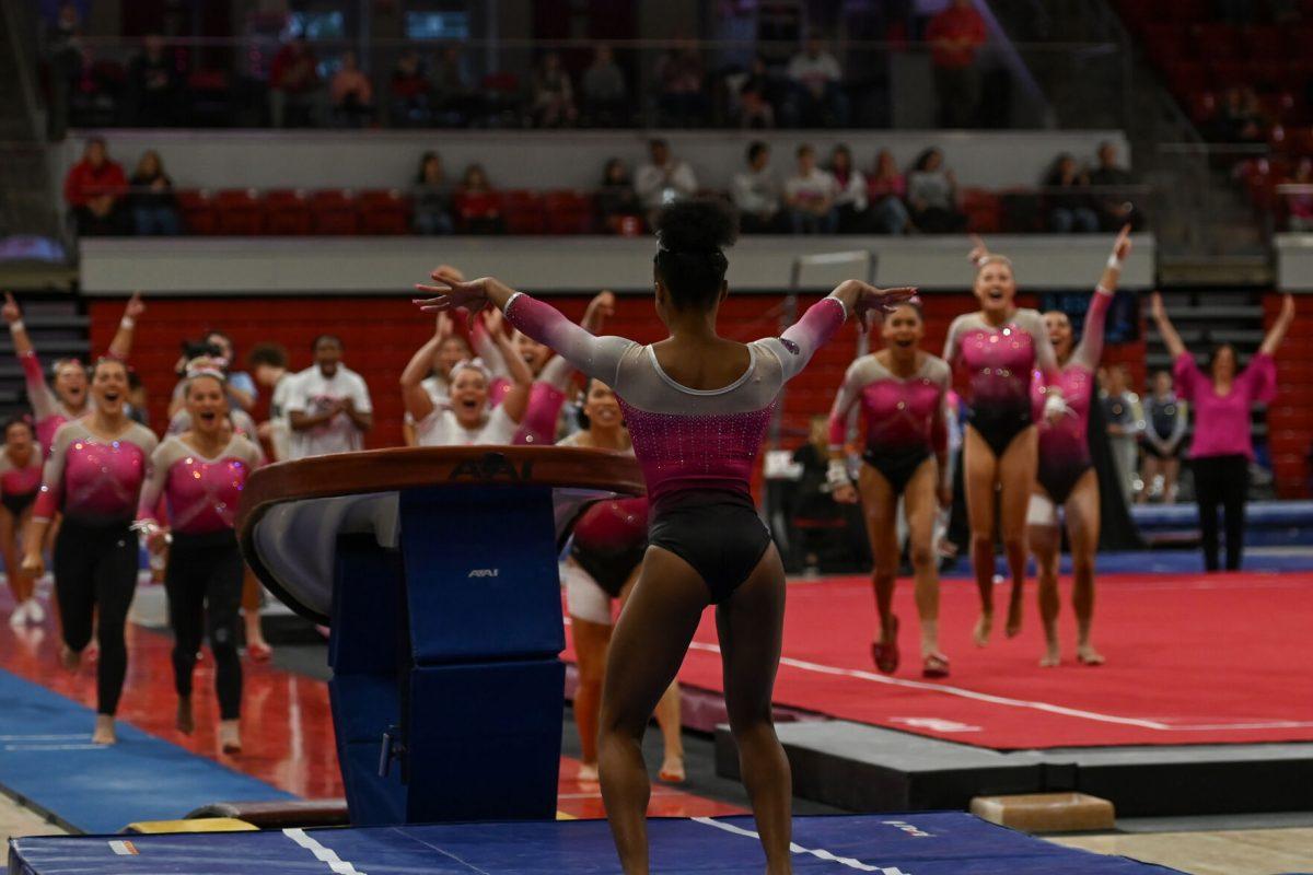 Sophomore Ashley Knight successfully sticks the landing to complete her routine on vault during the meet against the University of Pittsburgh in Reynolds Coliseum on Saturday, Feb. 8, 2025. Knight won the vault event with an average score of 9.900. The Wolfpack beat the Pitt Panthers 196.475 to 193.600.