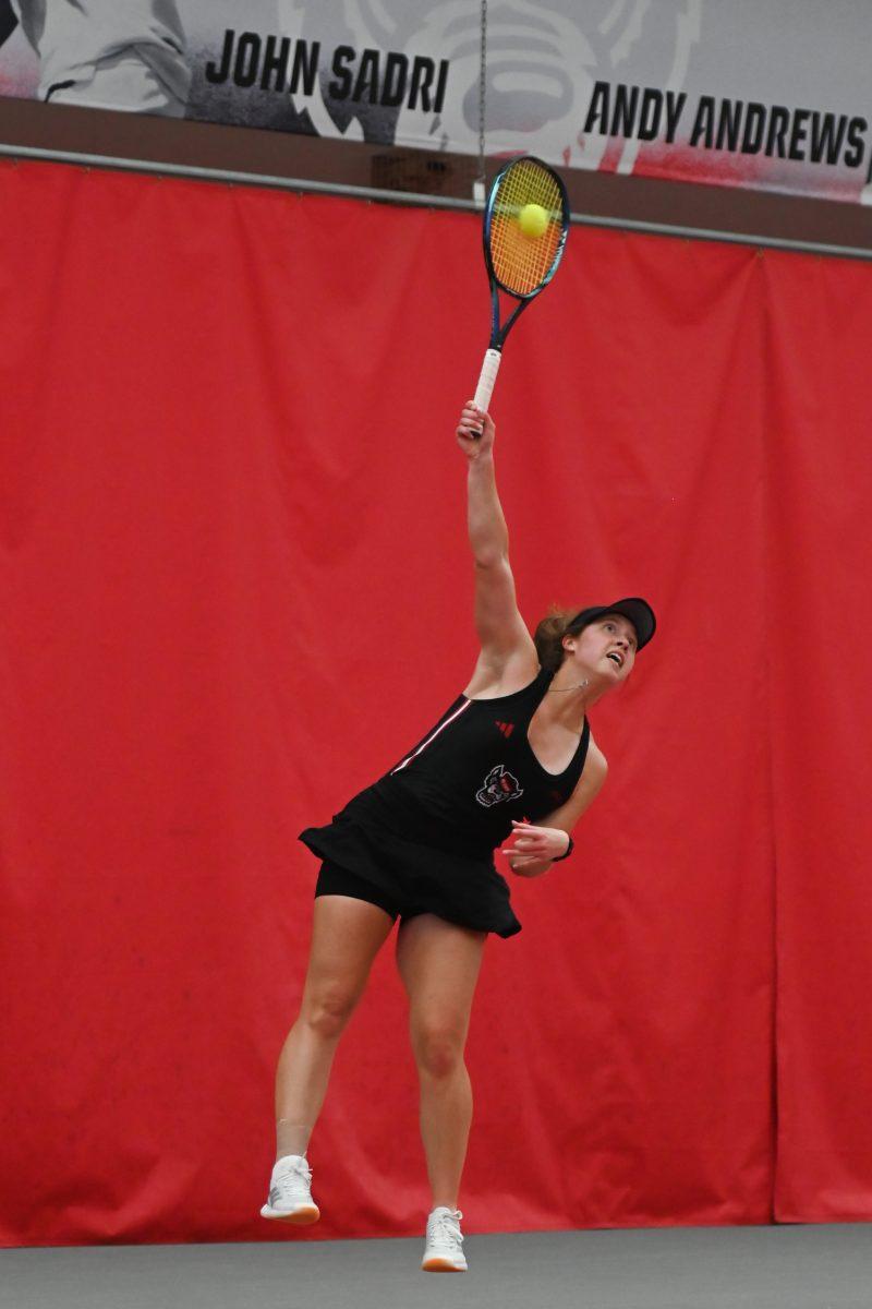 Junior Anna Zyryanova hits a serve during the match against Michigan at J. W. Isenhour Tennis Center on Friday, Feb. 14, 2025. Zyryanova lost her singles match 2-1. NC State beat Michigan 5-2.