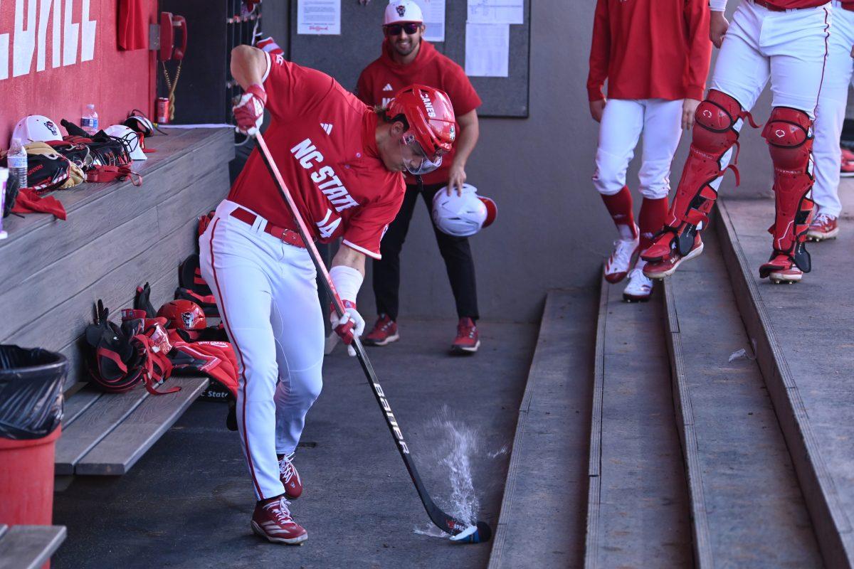 Freshman outfielder Ty Head preforms a hockey slapshot on a water cup as celebration for his grand slam home run during NC State's game against the Canisius Golden Griffins on Doak Field at Dail Park on Friday, Feb. 28, 2025. Head recorded five RBI's between the grand slam and a fly out. The Wolfpack beat the Golden Griffins 10-2 to take the first game of the series.