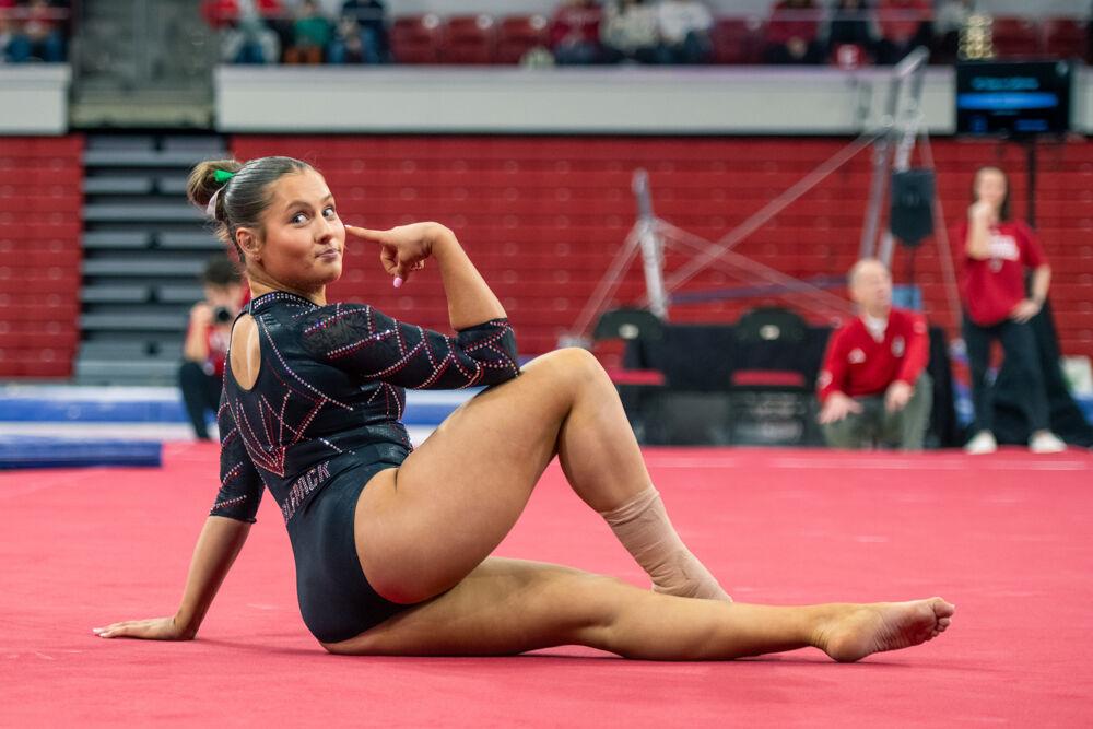 Sophomore Elle Hadrick points during the meet against California in Reynolds Coliseum on Sunday, Feb. 2, 2025. Hadrick scored 9.850 in the floor routine. The Wolfpack lost to the Bears 197.175-196.550