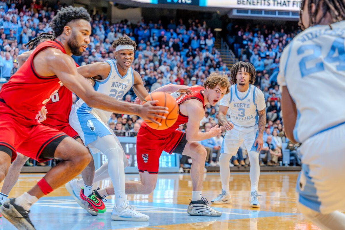 Senior forward Ben Middlebrooks passes the ball towards his teammate during the game against the University of North Carolina in the Dean E. Smith Center on Wednesday, Feb. 19, 2025. Middlebrooks scored zero points and made one rebound. NC State lost the game 97-73.