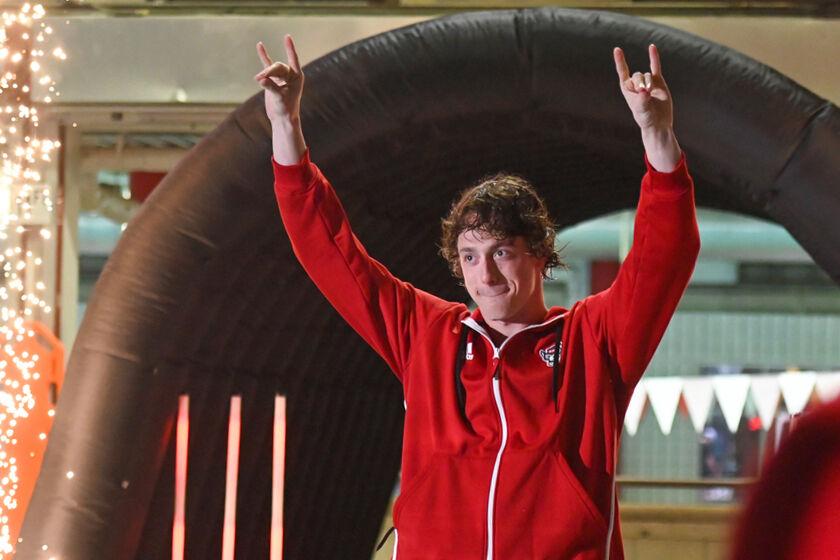 Senior Sam Hoover holds up "wolfies" during the senior night celebration before the swim meet against UNC-Wilmington at the Casey Aquatic Center on Friday, Jan. 31, 2025. The Wolfpack beat the Seahawks 161-114.