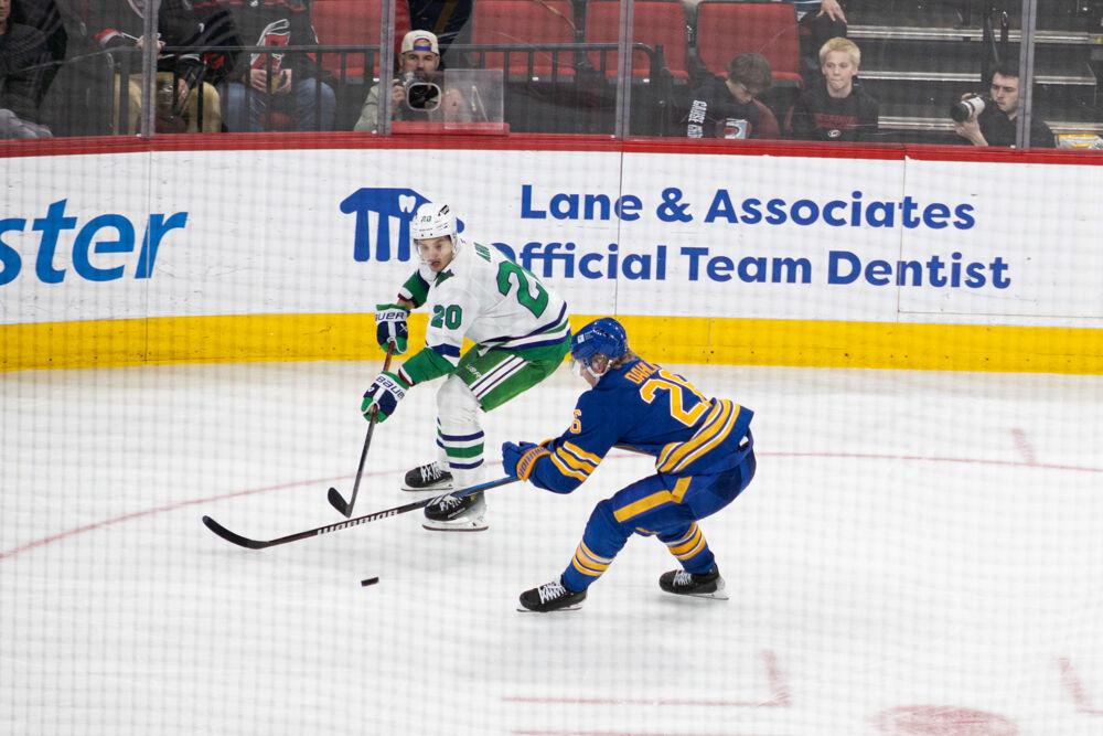 Center Sebastian Aho passes past defenseman during the Whalers Night game versus the Buffalo Sabres&#160;at the Lenovo Center on Thursday, Feb. 27, 2025. Aho scored one goal in the game. The Hurricanes beat the Sabres&#160;5-2.