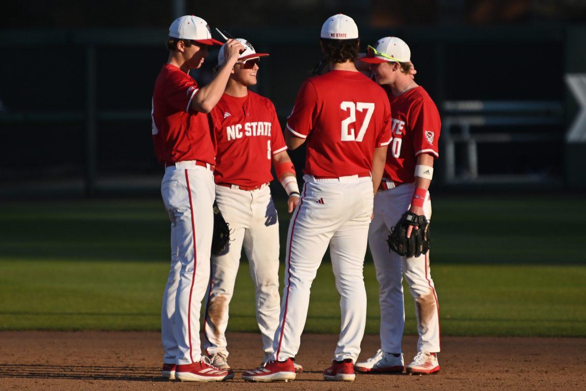 Members of the NC State infield huddle during a pitching change during NC State's game against the Canisius Golden Griffins on Doak Field at Dail Park on Friday, Feb. 28, 2025. The Wolfpack beat the Golden Griffins 10-2 to take the first game of the series.
