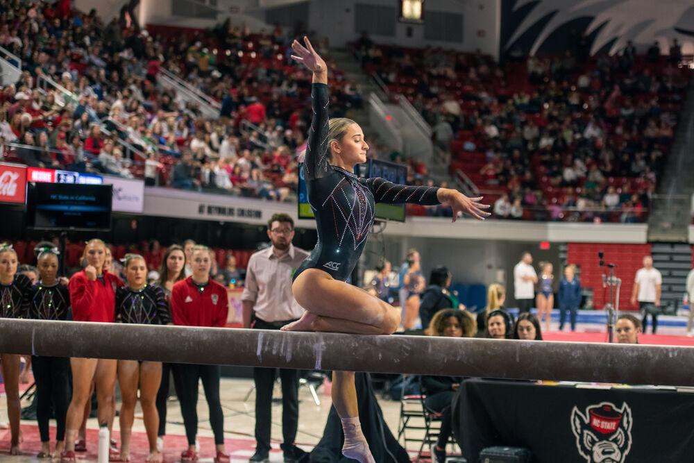 Senior Peyton Childs poses on the beam during the meet against California in Reynolds Coliseum on Sunday, Feb. 2, 2025. Childs scored 9.750 points on the balance beam. The Wolfpack lost to the Bears 197.175-196.550