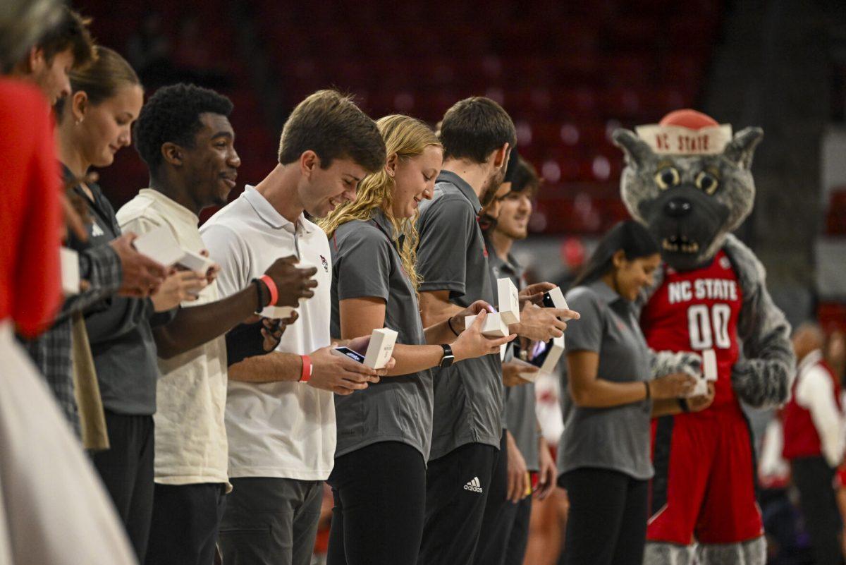 NC State students look at their rings during the halftime of NC State vs Anderson in Reynolds Coliseum on Tuesday, Oct. 29, 2024.