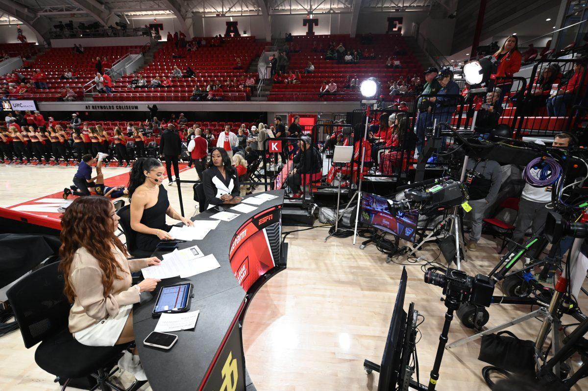ESPN College Gameday hosts Elle Duncan, Andraya Carter and Chiney Ogwumike sit at the desk in Reynolds Coliseum before the matchup between the thirteenth ranked NC State Wolfpack and the number one ranked Notre Dame Fighting Irish in Reynolds Coliseum on Sunday, Feb. 23, 2025. The Wolfpack beat the Fighting Irish 104-95 in double overtime.