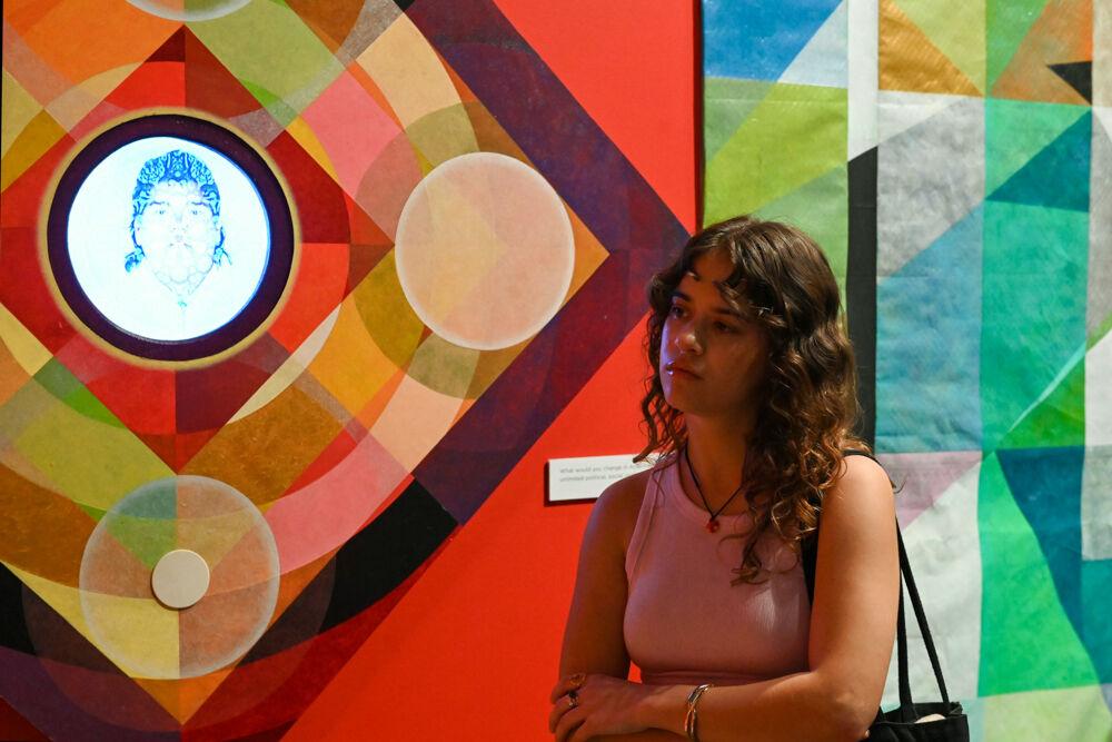 Haley Pierce, an NC State alum, gazes at an art piece at an opening exhibition by Carl Joe Williams at the Gregg Museum of Art &amp; Design on Thursday, Feb. 6, 2025. Williams' immersive exhibition titled "Amazing Grace" explores the complexities of race as a social construct.