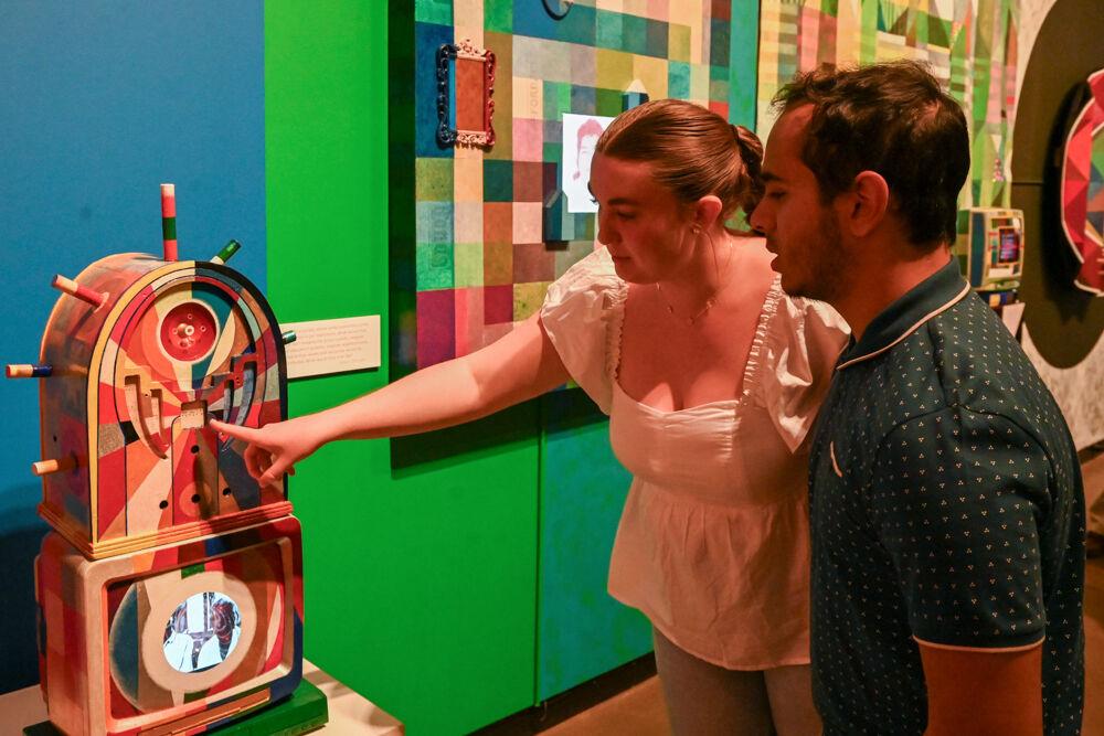 Alannah Anderson, a second-year studying marine science, and Sam Brown, a second-year studying computer science, examine an artwork at an opening exhibition by Carl Joe Williams at the Gregg Museum of Art &amp; Design on Thursday, Feb. 6, 2025.&#160;Williams' immersive exhibition titled "Amazing Grace" explores the complexities of race as a social construct.