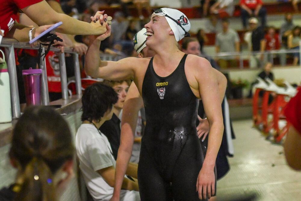 Senior Kenna Smallegange celebrates with a teammate during the swim meet against UNC-Wilmington in the Casey Aquatic Center on Friday,&#160;Jan. 31, 2025. The Wolfpack beat the Seahawks 176-111.