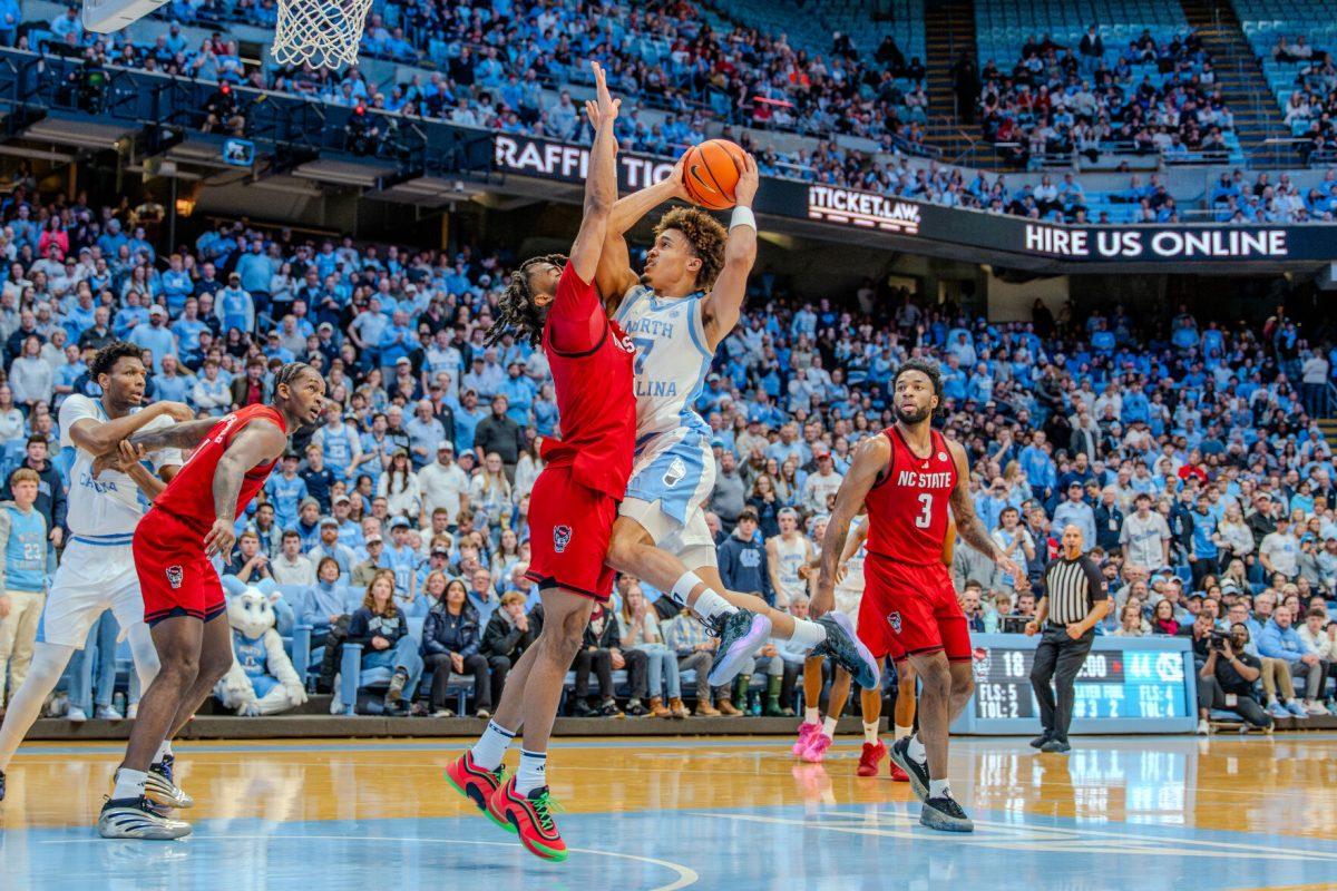 Sophomore guard Dennis Parker&#160;attempts to guard his opponent during the game against the University of North Carolina in the Dean E. Smith Center on Wednesday, Feb. 19, 2025. Parker scored three points and made one rebound. NC State lost the game 97-73.