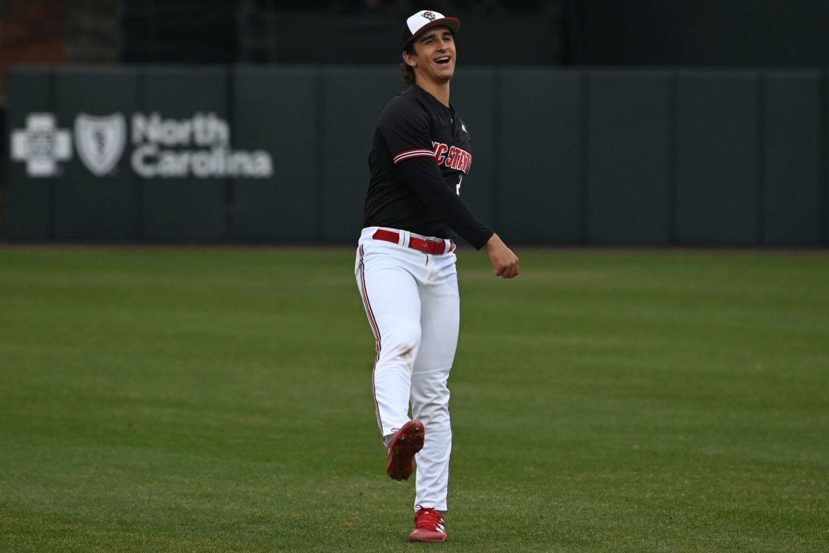 Sophomore infielder Chris McHugh laughs while warming up for the game against Fordham on Feb. 2, 2025 at Doak Field at Dail Park. McHugh scored a total of three runs. The Wolfpack defeated the Rams 19-6.