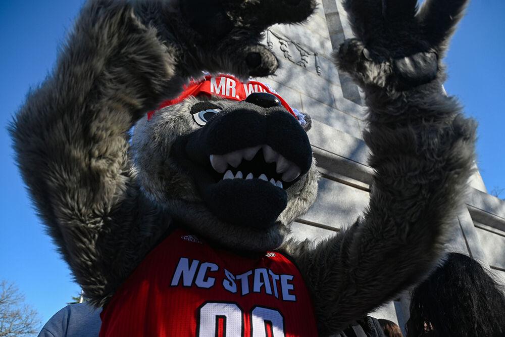 NC State's mascot, Mr. Wuf, celebrates NC State's upset win against Notre Dame with fans at the Memorial Belltower on Sunday, Feb. 23, 2025.