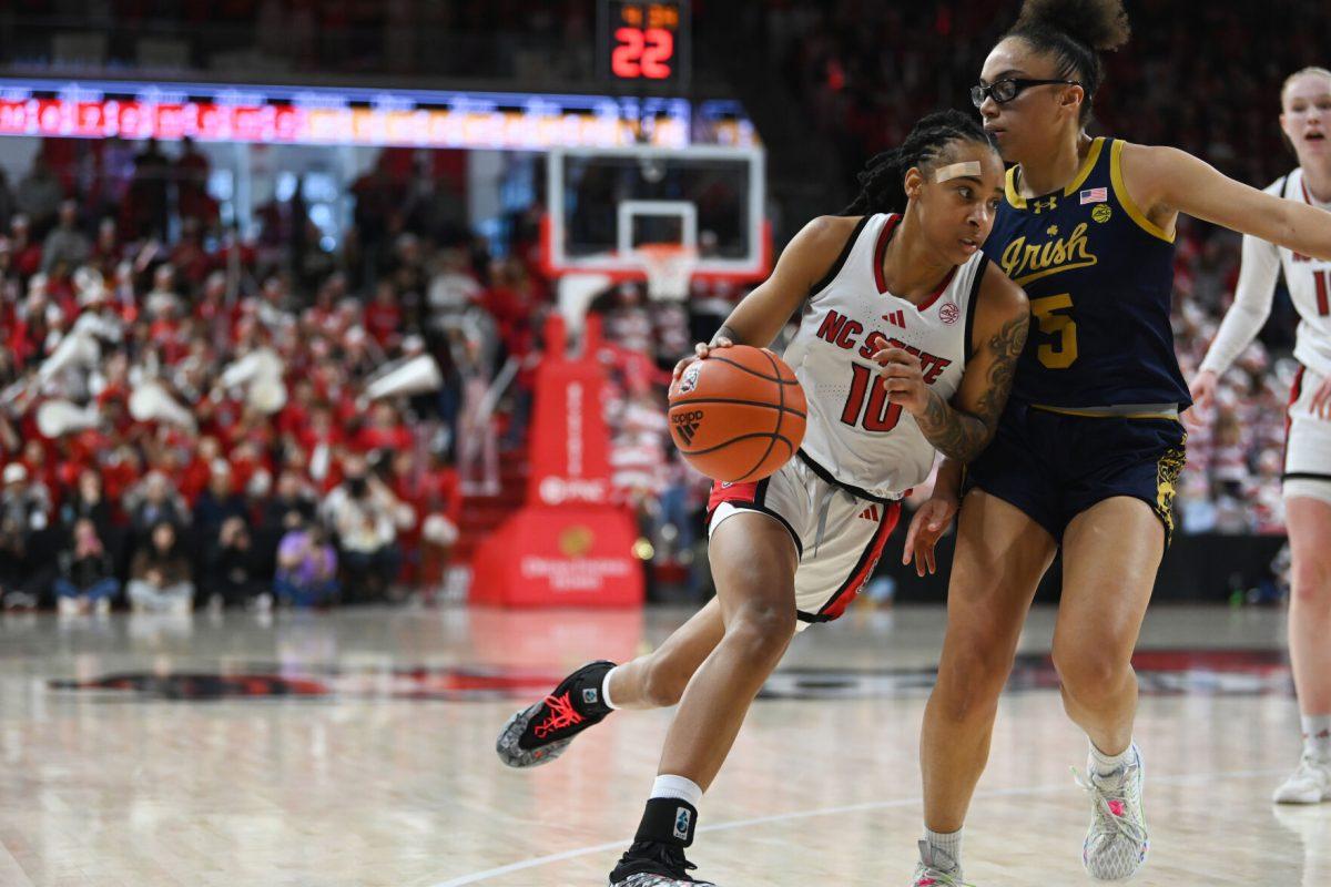 Senior guard Aziaha James dribbles to the net during NC State's game against Notre Dame in Reynolds Coliseum on Sunday, Feb. 23, 2025. The Wolfpack beat the Fighting Irish 104-95.