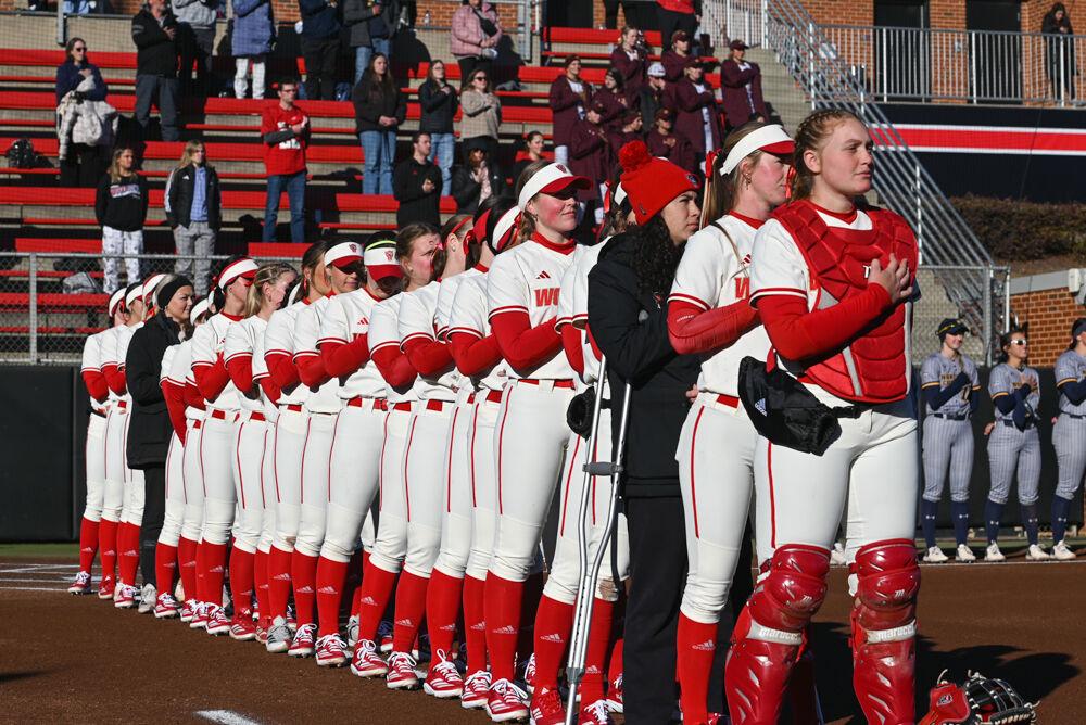 NC State's softball team lines up at the foul line for the Pledge of Allegiance at Dail Softball Stadium before the game against Northern Colorado in the Marucci Classic on Friday, Feb. 21, 2025. The game ended in a walkoff in the sixth inning. The Wolfpack defeated the Bears 11-1