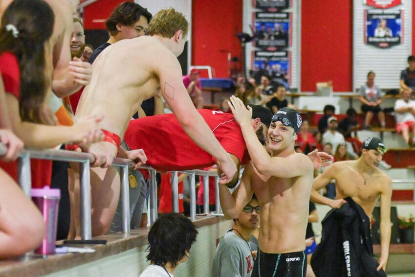 Sophomore Wells Walker celebrates with head coach Braden Holloway during the meet against UNC-Wilmington in the Casey Aquatic Center on Friday,&#160;Jan. 31, 2025. NC State beat UNC-Wilmington 161-114.