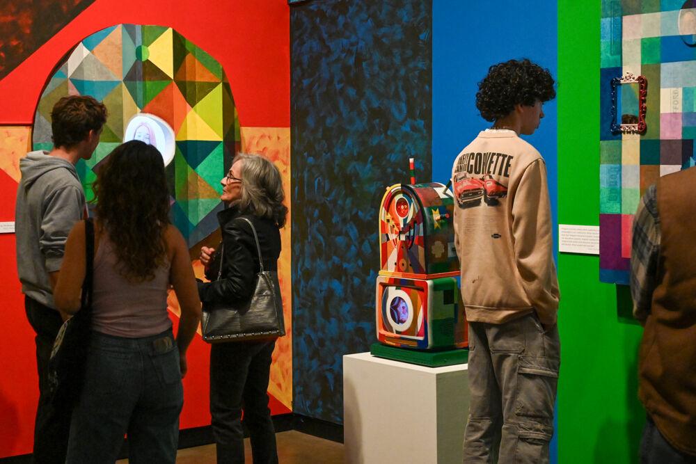 Museum goers observe artworks at an opening exhibition by Carl Joe Williams at the Gregg Museum of Art &amp; Design on Thursday, Feb. 6, 2025.&#160;Williams' immersive exhibition titled "Amazing Grace" explores the complexities of race as a social construct.