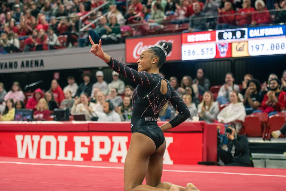 Sophomore Ashley Knight holds up a wolfie during the meet against California in Reynolds Coliseum on Sunday, Feb. 2, 2025. Knight scored 9.925 points during the floor routine. The Wolfpack lost to the Bears 197.175-196.550
