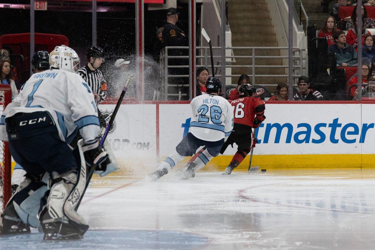 Freshman forward Daniel Prazma chased by a defender during the Governors Cup against the University of North Carolina at the Lenovo Center on Sunday, Feb. 2, 2025. The Wolfpack beat The Tarheels 4-1.