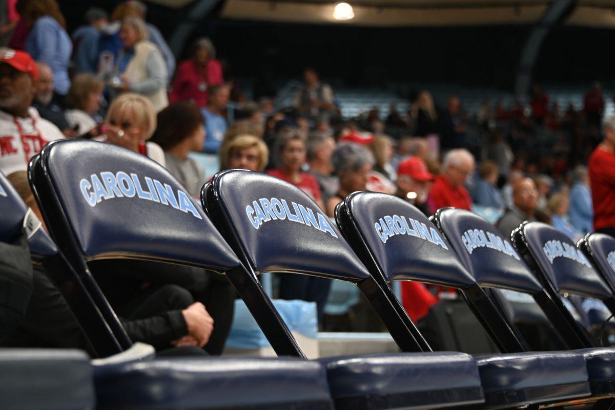 Empty chairs line the NC State bench before tipoff against UNC on Sunday, Feb. 16, 2025, in Carmichael Arena. UNC defeated NC State 66-65.
