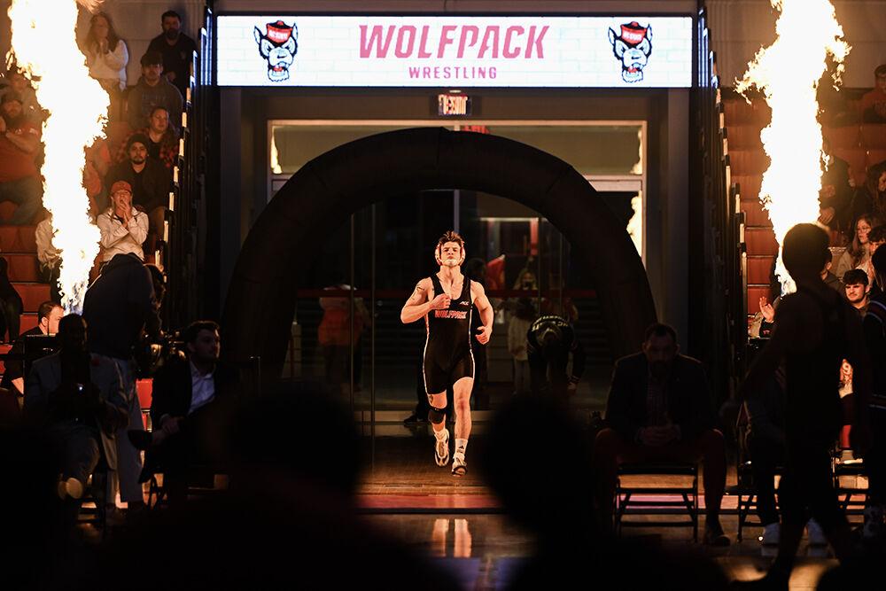 Senior Ed Scott runs onto the mat before his bout during the duel against Stanford in Reynolds Coliseum on Friday, Feb. 14, 2025. Scott won the 157 bout 13-3. NC State beat Stanford 27-13.
