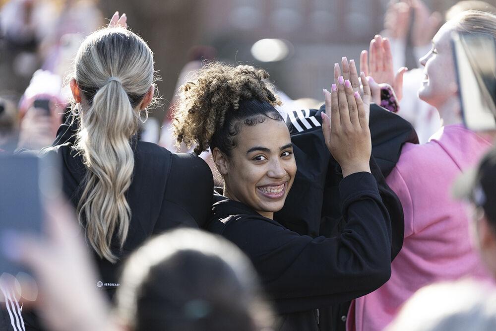 Graduate guard Madison Hayes applauses and thanks the fans at the Memorial Belltower on Sunday, Feb. 23, 2025. The women's basketball team celebrated their victory over Notre Dame with fans at the Belltower and thanked them for their support.