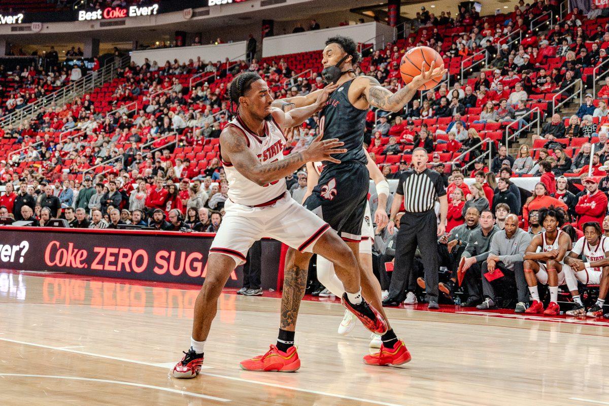 Senior guard Marcus Hill attacks the ball during the game against University of Louisville in the Lenovo Center on Wednesday, Feb. 12, 2025. Hill scored 10 points and made three rebounds. NC State lost the game 91-61.