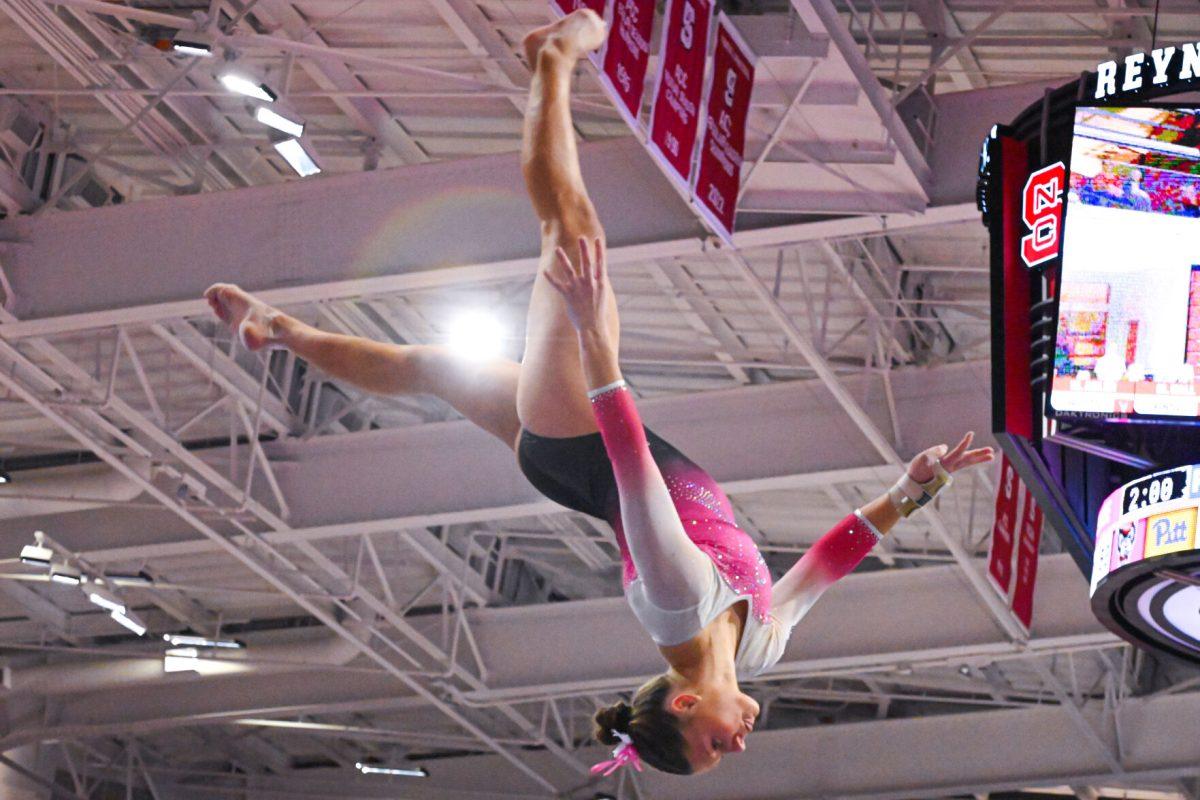 Freshman Caroline Volk preforms a flip on the balance beam during the meet against Pittsburgh at Reynolds Coliseum on Saturday, Feb. 8, 2025. Volk scored a 9.675 on the balance beam. NC State beat Pittsburgh 196.475-193.600.