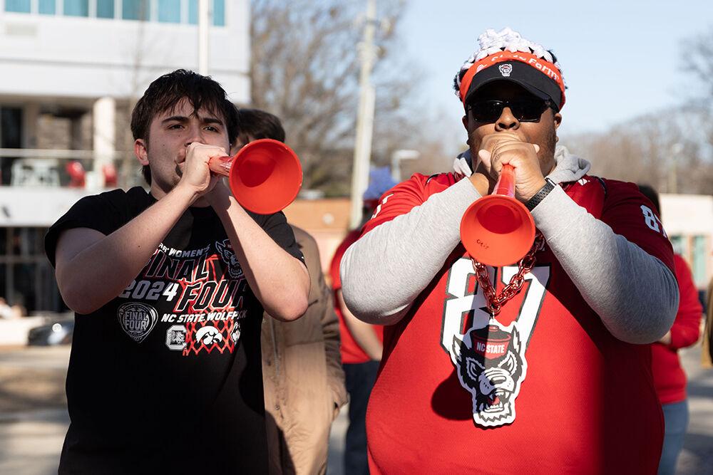 Xander Sechiest, a third-year studying business analytics, and Otis Robinson, a third-year studying nuclear engineering, hype up the crowd at the Memorial Belltower on Sunday, Feb. 23, 2025. The crowd celebrated a women's basketball upset over Notre Dame, the #1 team in the nation.