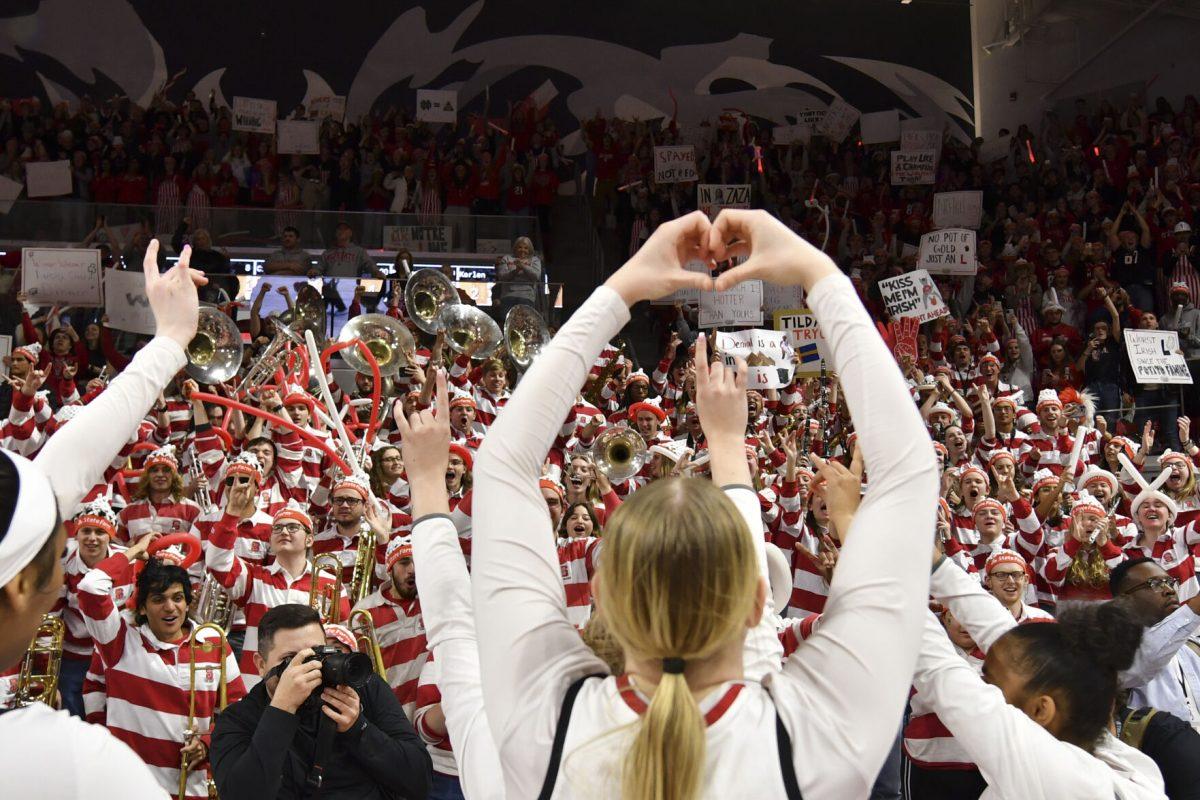 Sophomore forward Maddie Cox makes a heart with her hands towards the student section and band after NC State's double overtime game against the top ranked Notre Dame Fighting Irish in Reynolds Coliseum on Sunday, Feb. 23, 2025. The Wolfpack beat the Fighting Irish 104-95.