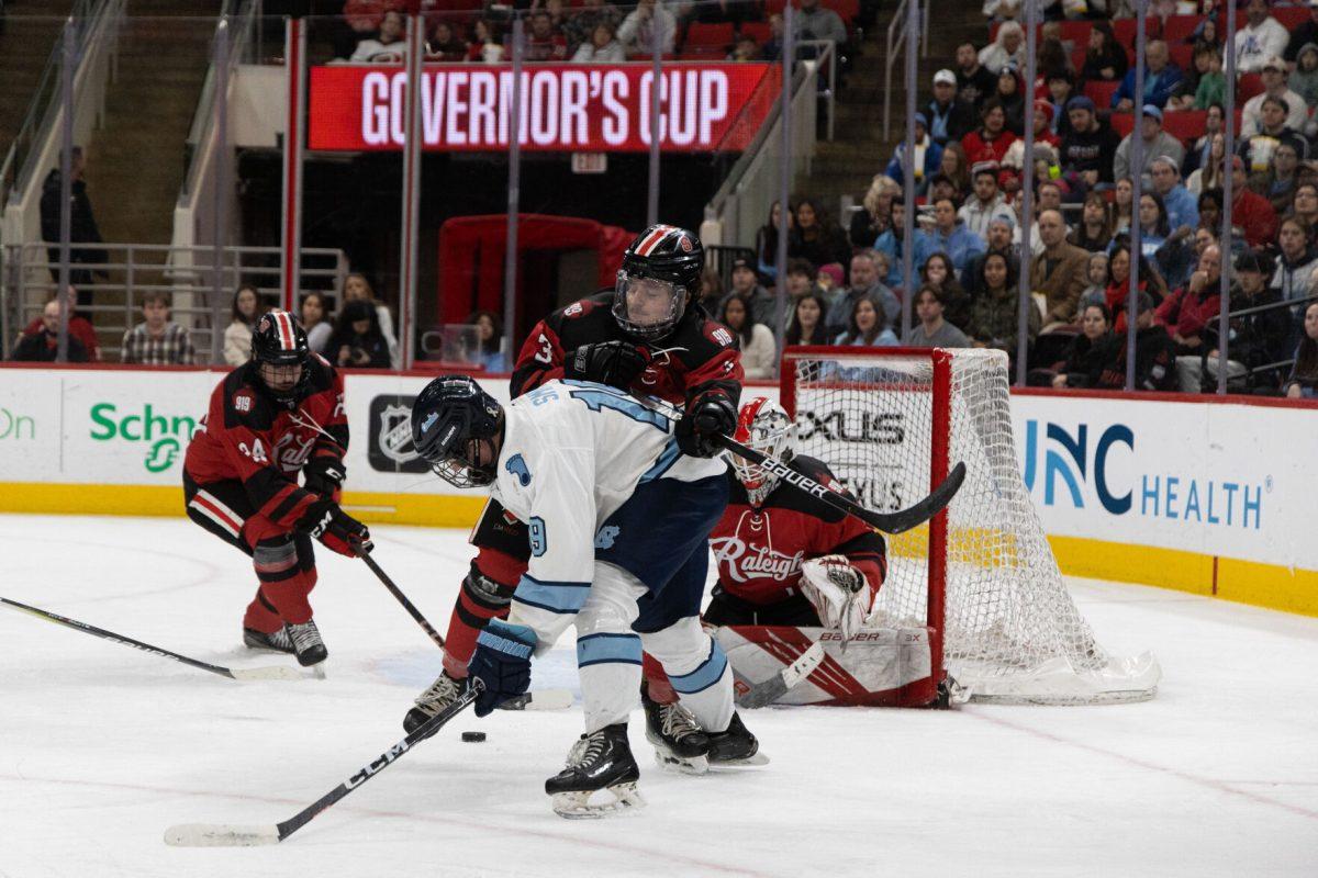 Freshman defenseman Jackson Weglarz pushes Carolina&#8217;s Junior Forward Will Smith during the Governors Cup against the University of North Carolina at the Lenovo Center on Sunday, Feb. 2, 2025. The Wolfpack beat The Tarheels 4-1.