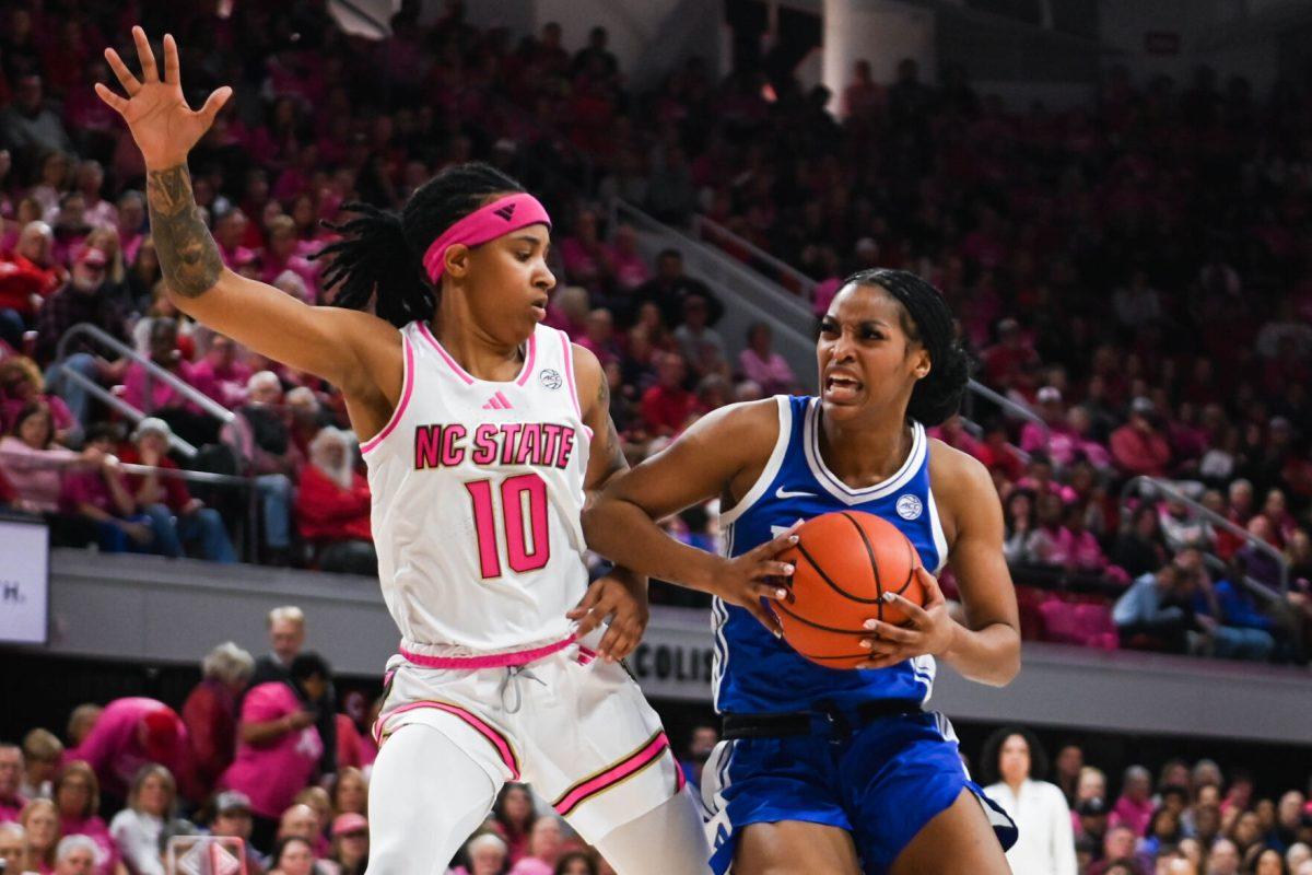 Senior guard Aziaha James blocks her opponent during the Play4Kay game against Duke at Reynolds Coliseum on Monday, Feb. 3, 2025. James scored a career-high of 36 points for NC State. The Wolfpack beat the Blue Devils 89-83.