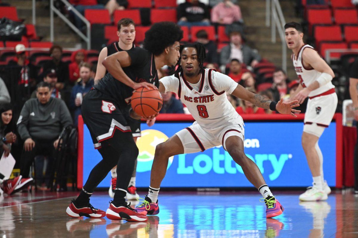 Senior guard Jayden Taylor defends an opponent during the match against Louisville in the Lenovo Center on Wednesday, Feb. 12, 2025. Taylor had two rebounds and scored three points. The Wolfpack lost to the Cardinals 91-66.