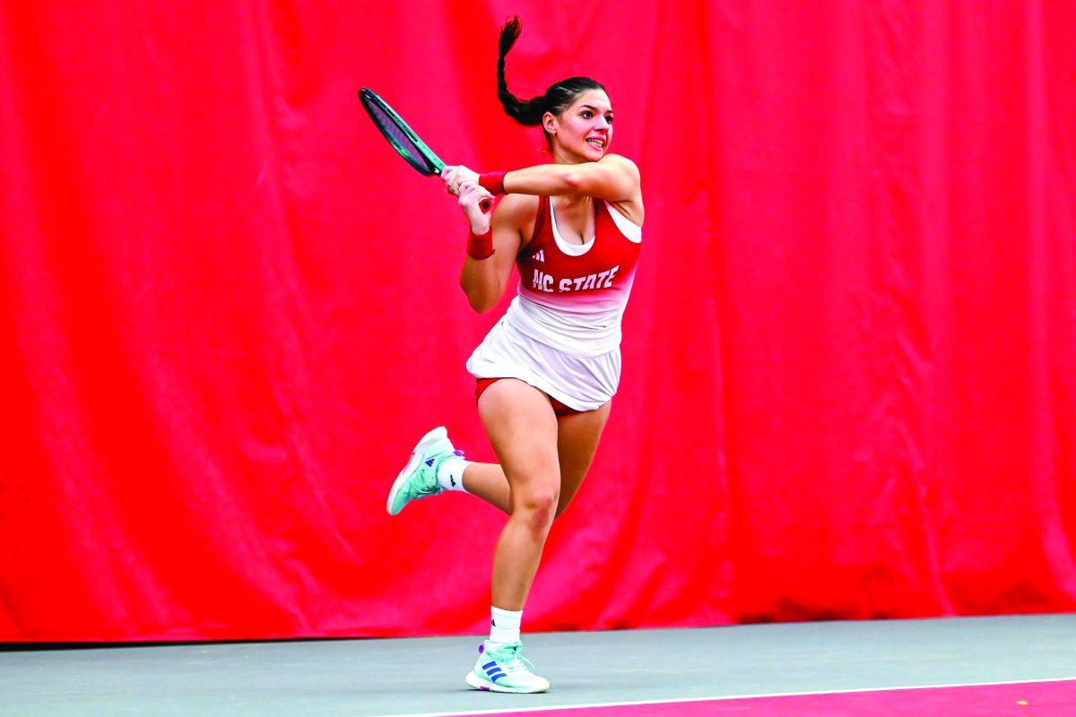 Freshman Michaela Laki backhands the ball in her singles game against Campbell player Sonia Pieczynska on Friday, Jan. 17, 2025 at the J.W. Isenhour Tennis Center. Laki won her singles match 2-0, with scores of 6-0 and 6-1 for the individual sets. NC State won the match 7-0.