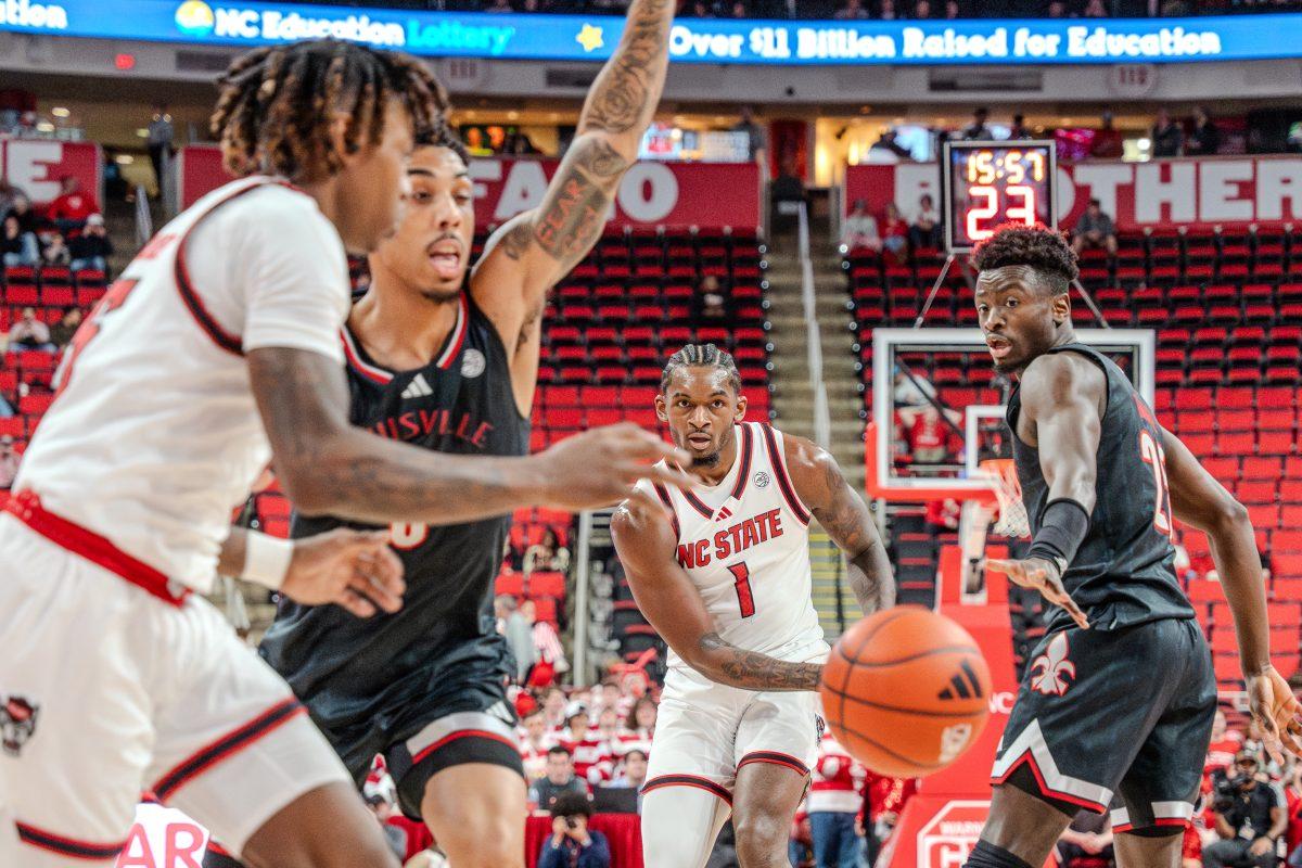 Senior forward Brandon Huntley-Hatfield passes the ball towards his teammate during the game against University of Louisville in the Lenovo Center on Wednesday, Feb. 12, 2025. Huntley-Hatfield scored four points and made 10 rebounds.&#160;NC State lost the game 91-61.