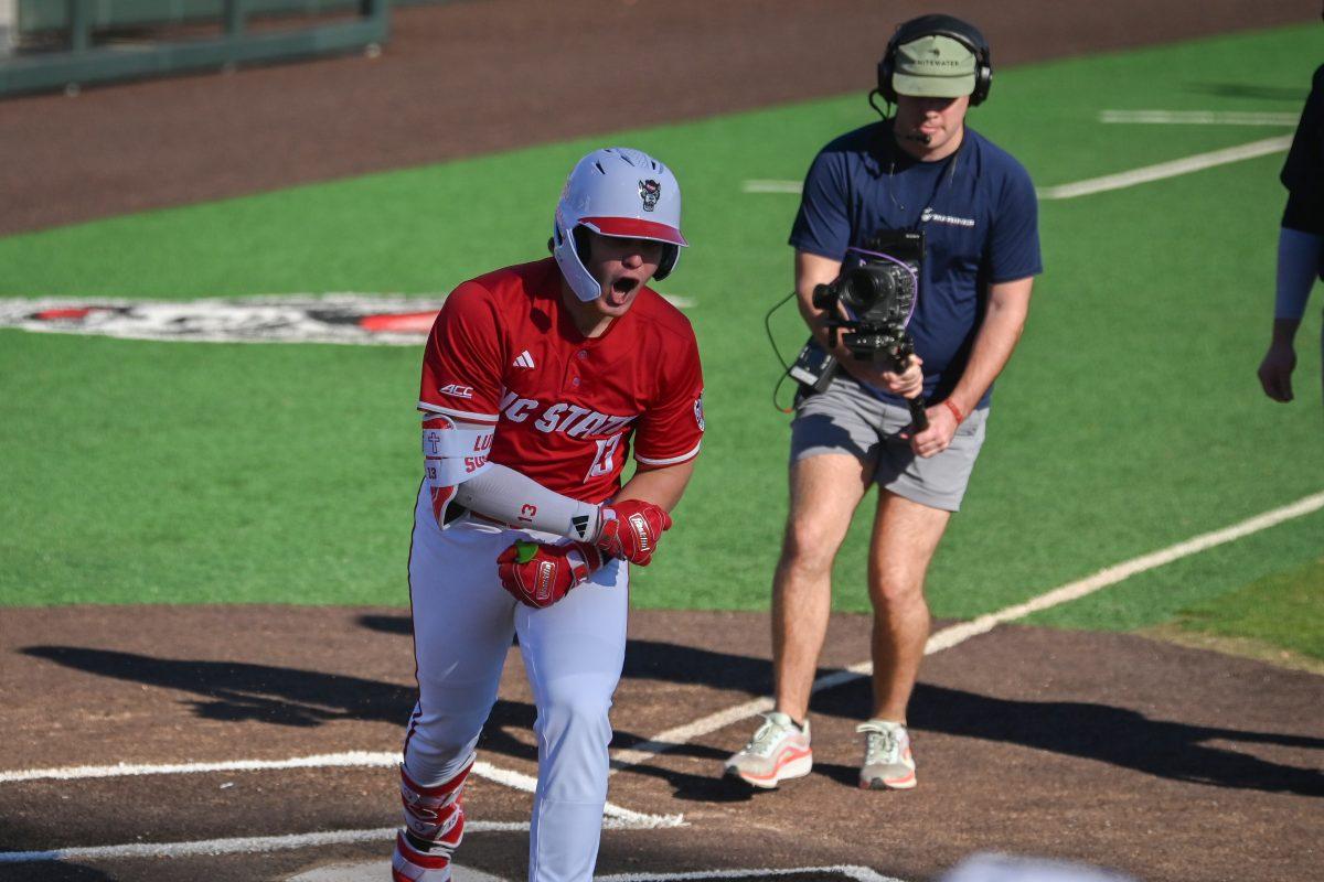 Sophomore catcher Alex Sosa celebrates crossing home plate after his solo home run during NC State's game against the Canisius Golden Griffins on Doak Field at Dail Park on Friday, Feb. 28, 2025. Sosa recorded one run on two hits. The Wolfpack beat the Golden Griffins 10-2 to take the first game of the series.