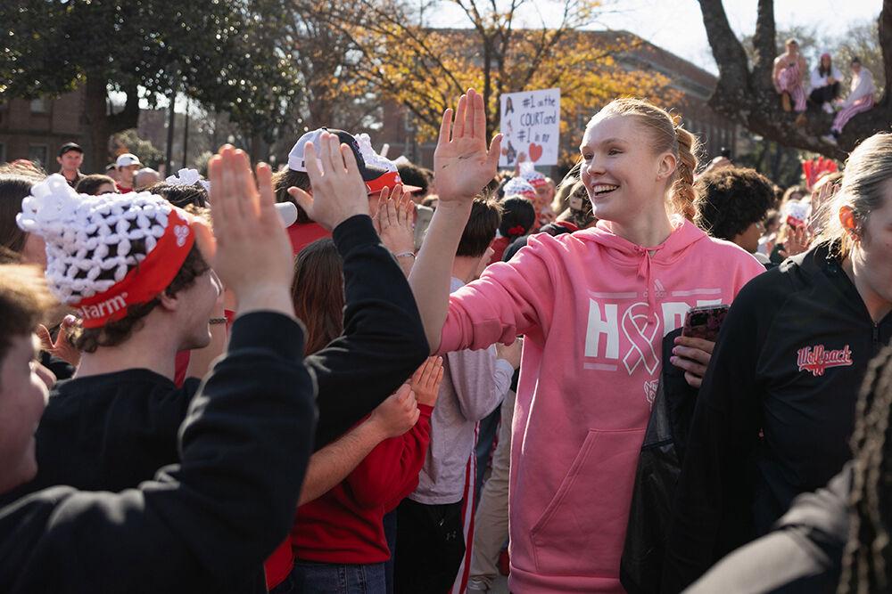 Freshman forward Tilda Trygger smiles as she high-fives fans at the Memorial Belltower on Sunday, Feb. 23, 2025. Fans handed out and waved Swedish flags during the game to celebrate Trygger's hometown of Stockholm, Sweden.