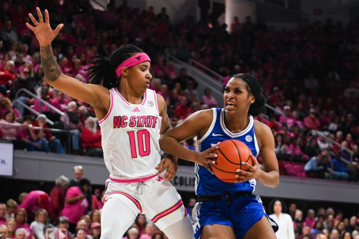 Senior guard Aziaha James blocks her opponent during the Play4Kay game against Duke at Reynolds Coliseum on Monday, Feb. 3, 2025. James scored a career-high of 36 points for NC State. The Wolfpack beat the Blue Devils 89-83.