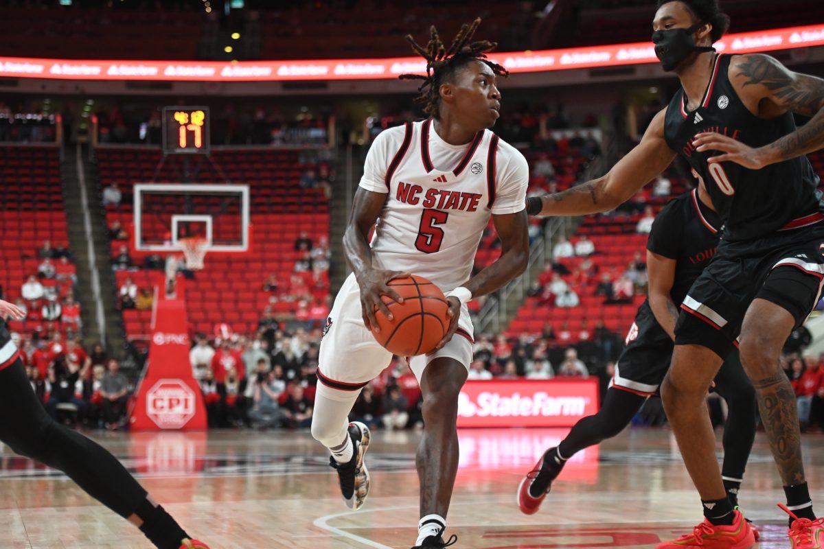 Freshman guard Trey Parker defends the ball during the match against Louisville in the Lenovo Center on Wednesday, Feb. 12, 2025. Parker had one rebound and scored 13 points. The Wolfpack lost to the Cardinals 91-66.