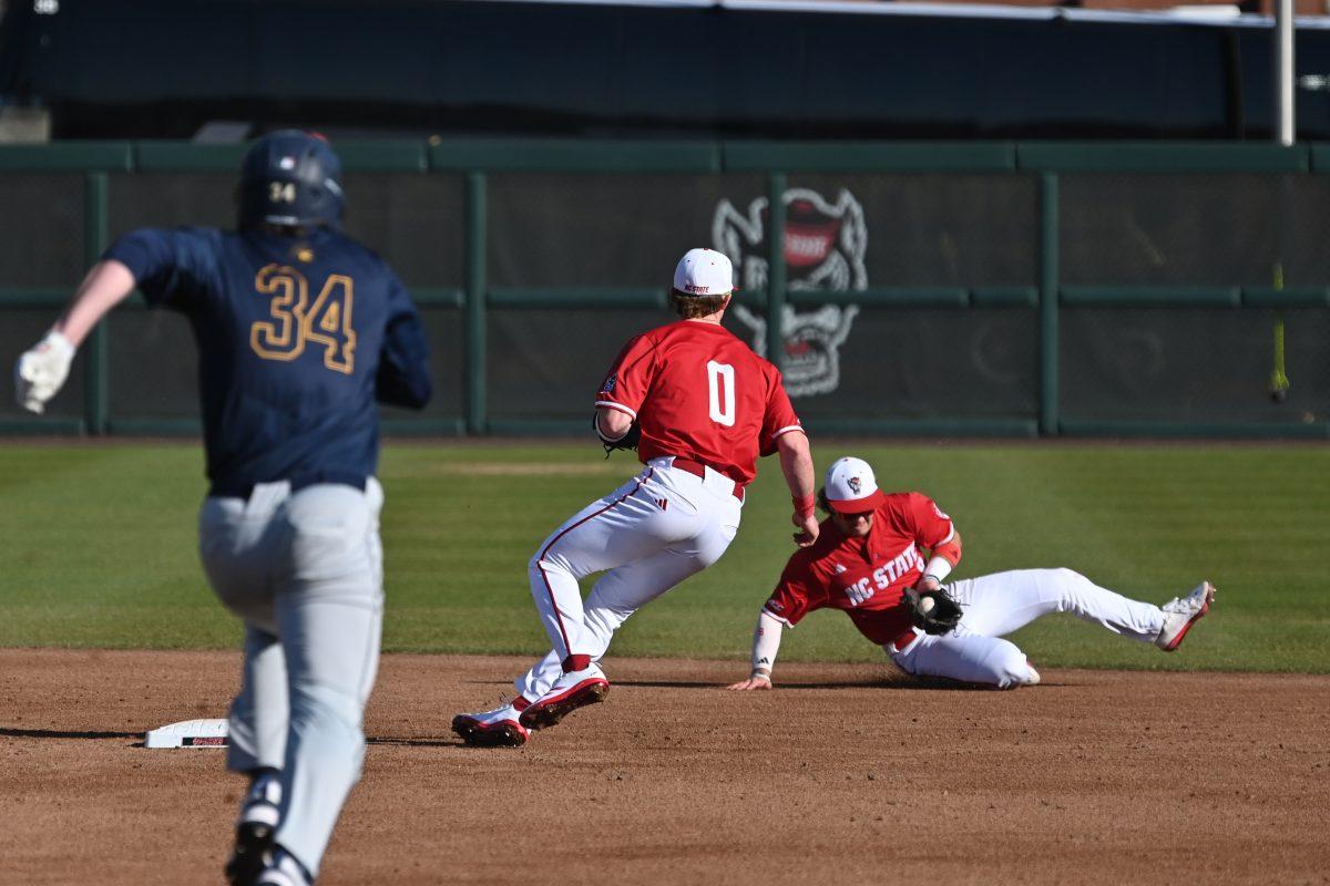 Senior infielder Justin DeCriscio lays out and makes the play to sophomore infielder Luke Nixon for the out during NC State's game against the Canisius Golden Griffins on Doak Field at Dail Park on Friday, Feb. 28, 2025. The Wolfpack beat the Golden Griffins 10-2 to take the first game of the series.