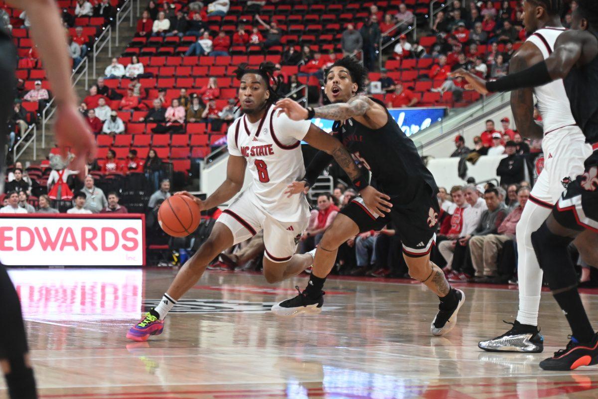 Senior guard Jayden Taylor defends the ball during the match against Louisville in the Lenovo Center on Wednesday, Feb. 12, 2025. Taylor had two rebounds and scored three points. The Wolfpack lost to the Cardinals 91-66.
