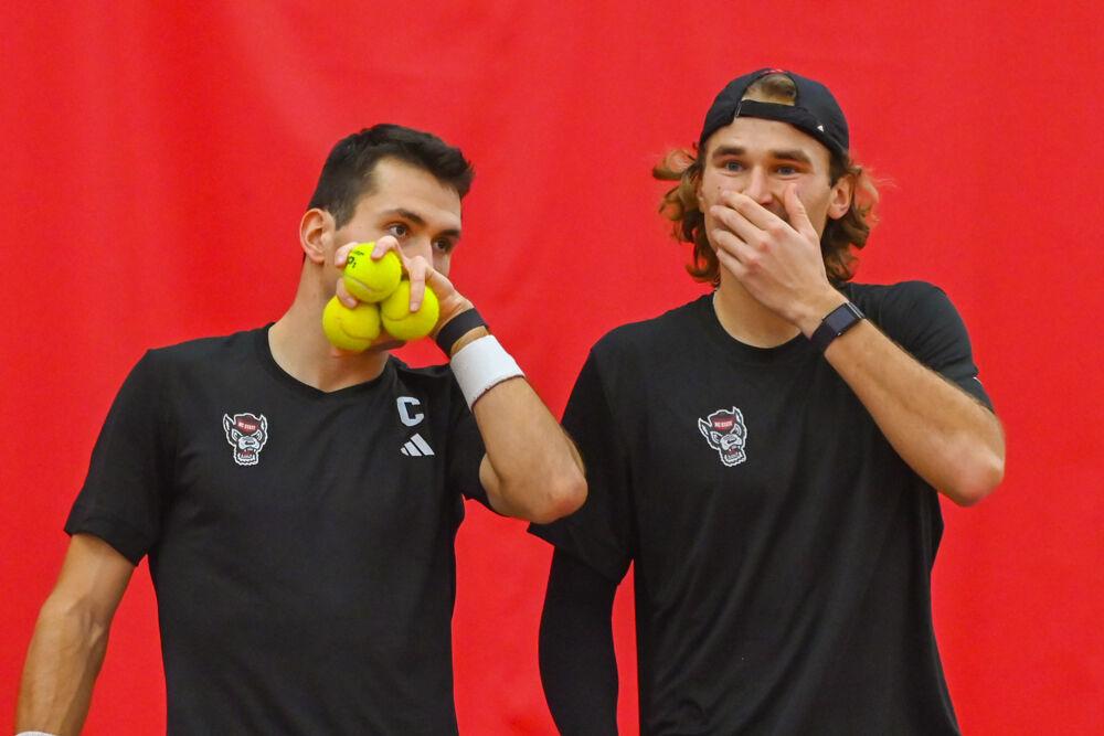 Junior Martin Borisiouk talks with senior Luca Staeheli during their doubles game against NC Central at the J.W. Isenhour Tennis Center&#160;on Saturday, Jan. 18, 2025. Borisiouk and Staeheli won their doubles match 5-3 (unfinished). NC State won the match 7-0.